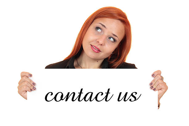 Woman holding a sign with 'contact us' text on a white background